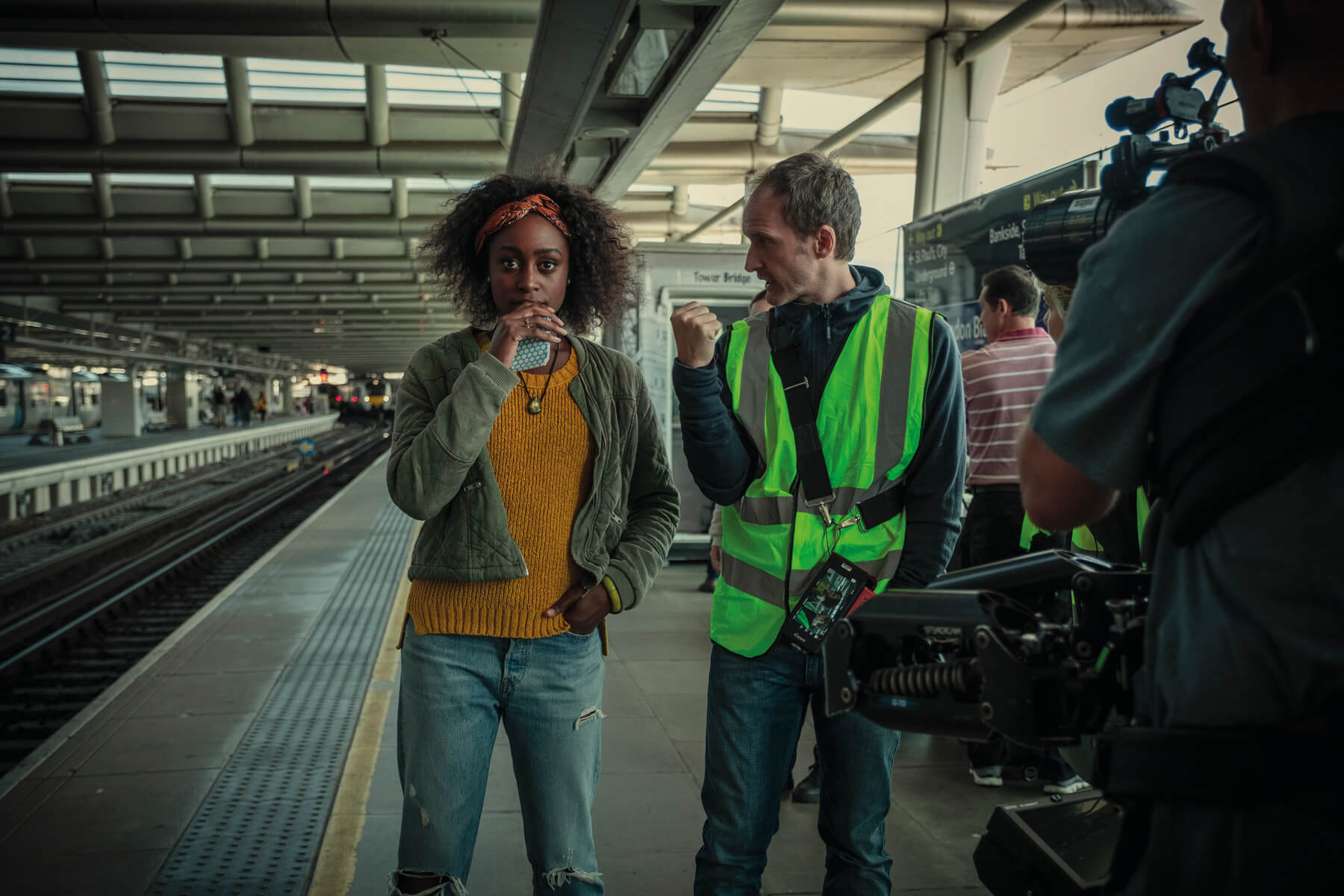 Simona Brown stands with crew, preparing for a train station scene in Behind Her Eyes