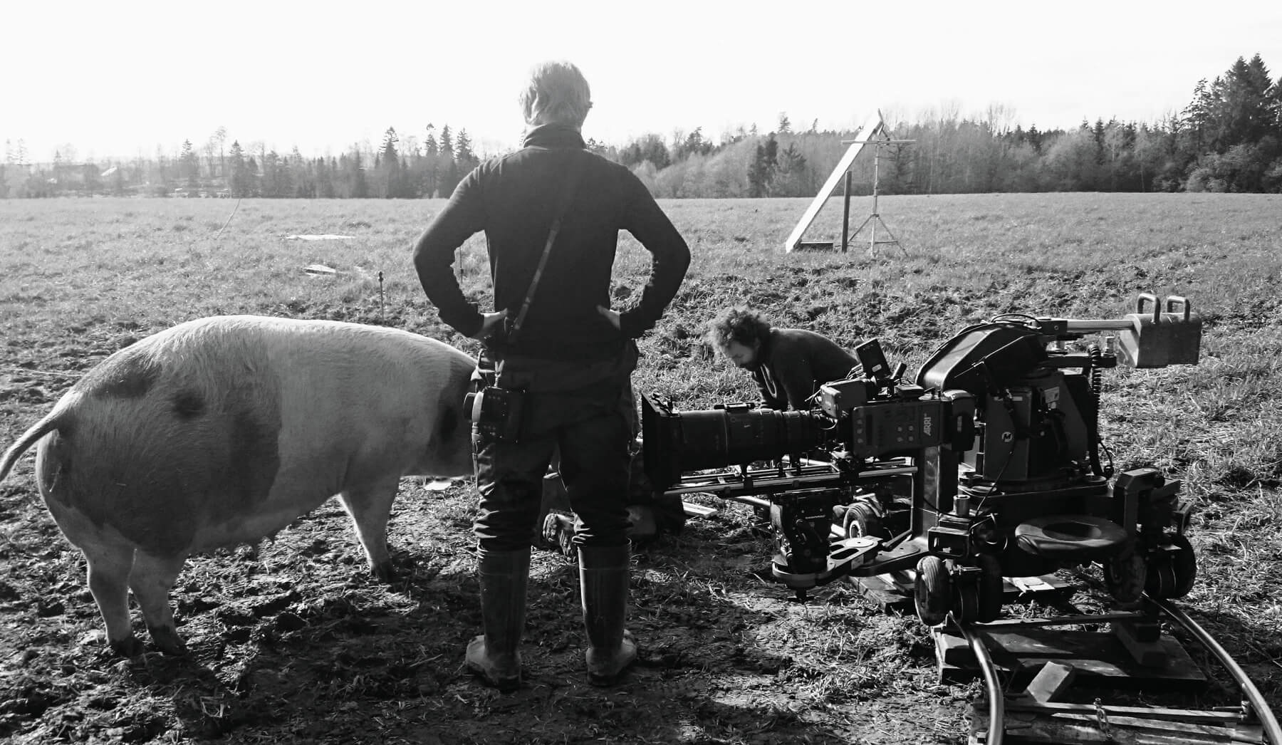 DOP Egil Håskjold Larsen stands between his camera and the eponymous pig on the location of Gunda