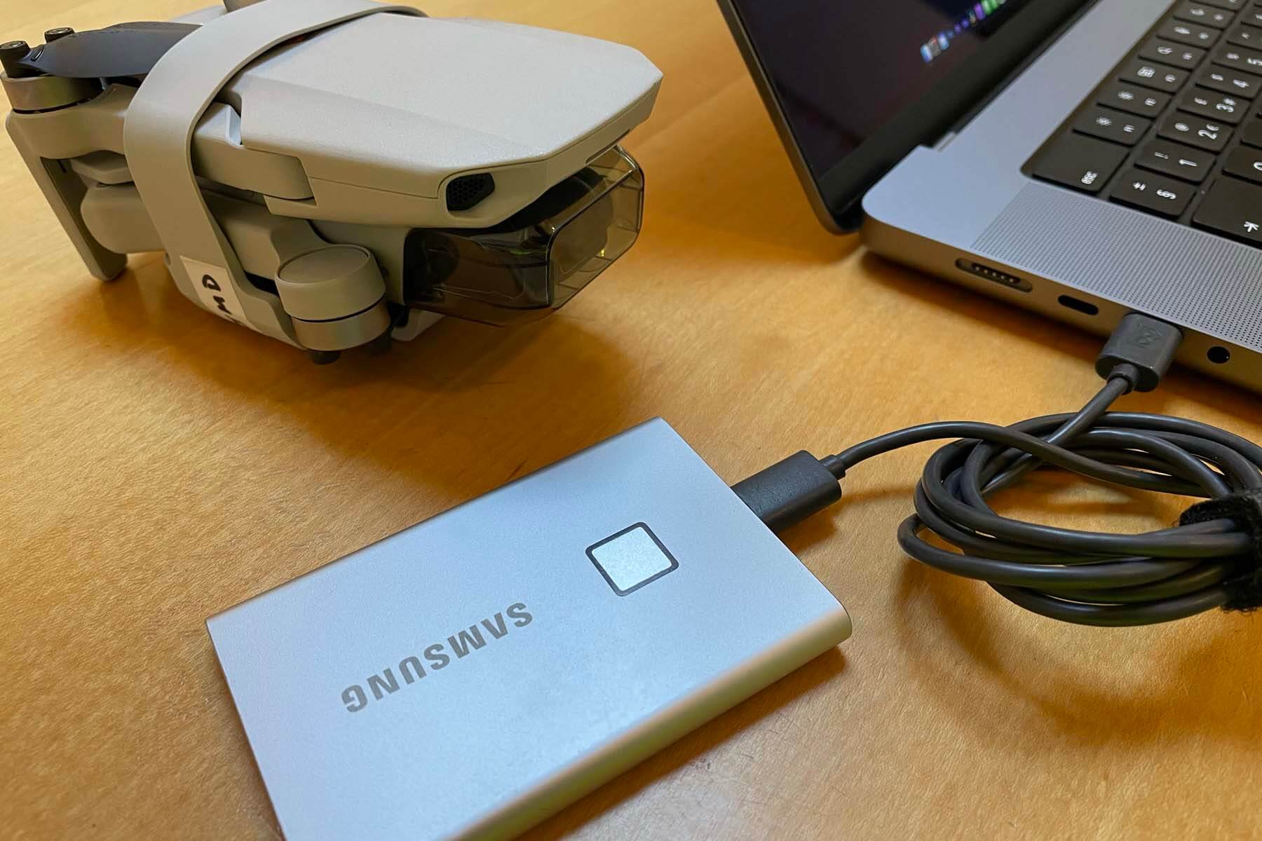 Samsung Portable SSD T7 Touch next to laptop and drone on desk