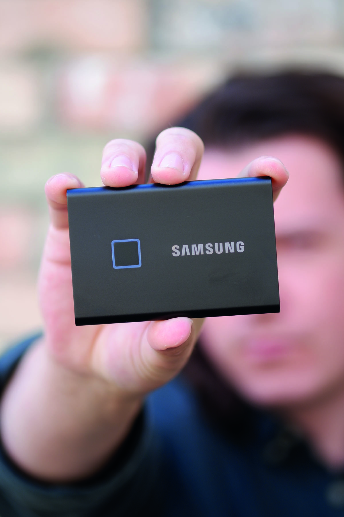 Man holding Samsung Portable SSD T7 Touch