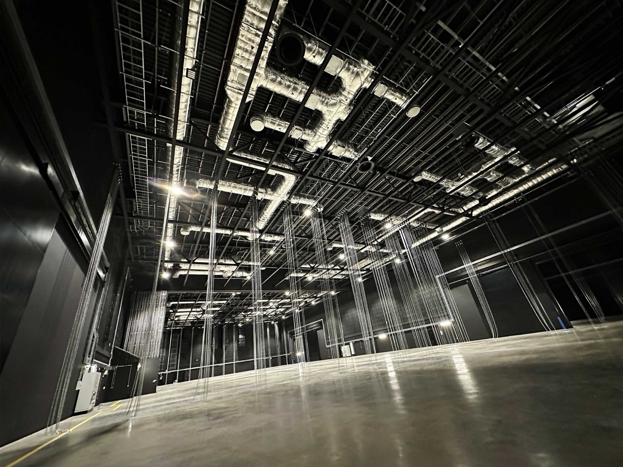 Inside of Eastbrook Studios production campus with exposed pipes and wires on the ceiling