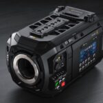 A black camera with many buttons on the side against a black background. Shows the URSA Cine 12K