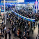 A large crowd of people in the entrance of a large building at ISE 2025