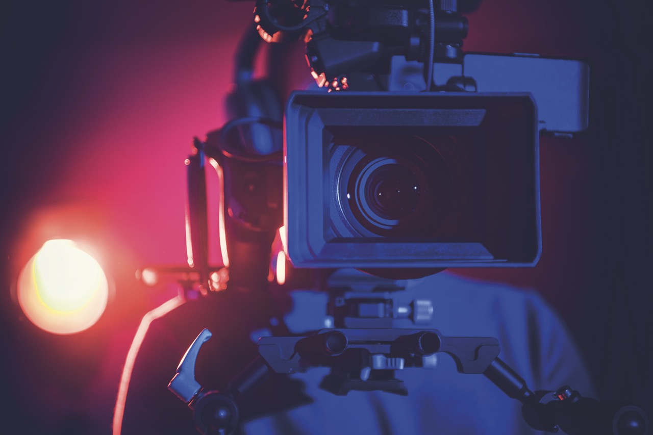 large camera backlit with purple and blue light