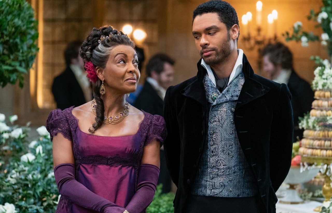 Two people in period drama clothing at a ball