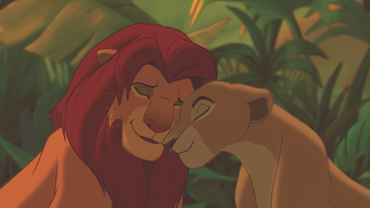 A screenshot of the animation, “The Lion King”. A lion and lioness sit close together