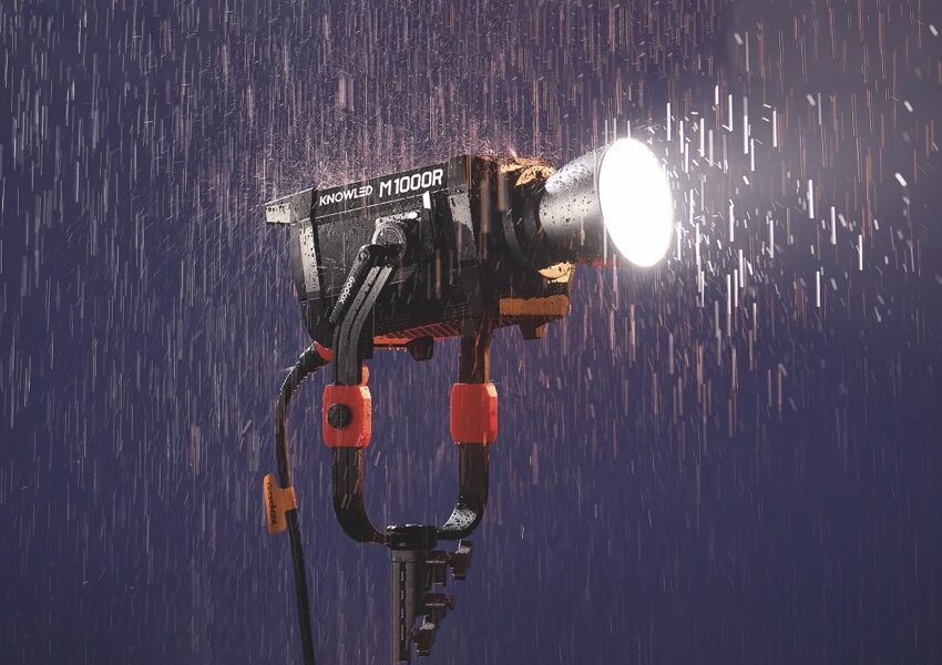 A professional light on a stand placed in heavy rain