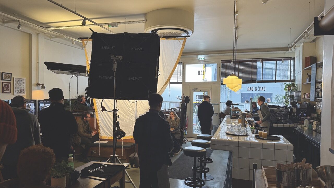 A film set inside a cafe Many people monitor the scene