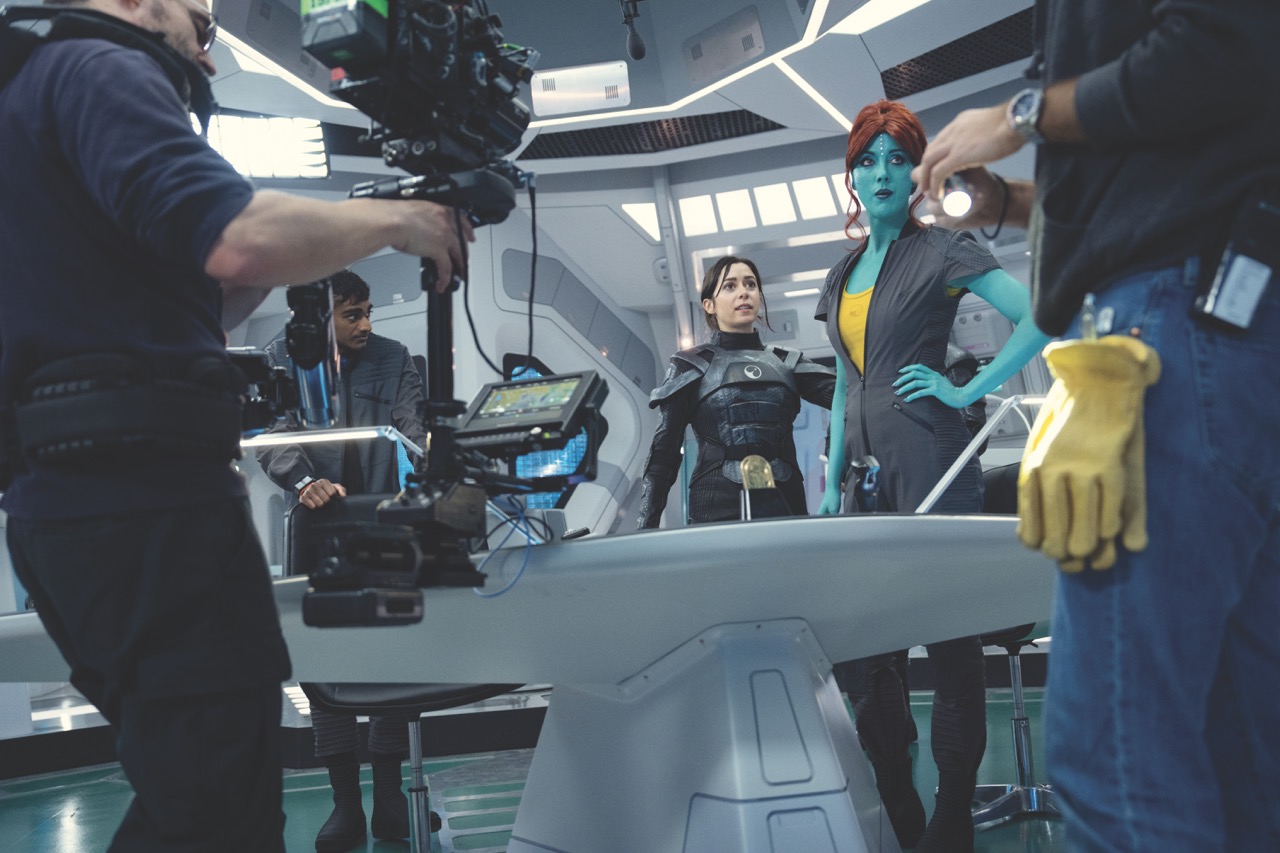Actors in sci-fi costumes being filmed by a team