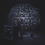 A sphere made of different lights with an amp placed in front