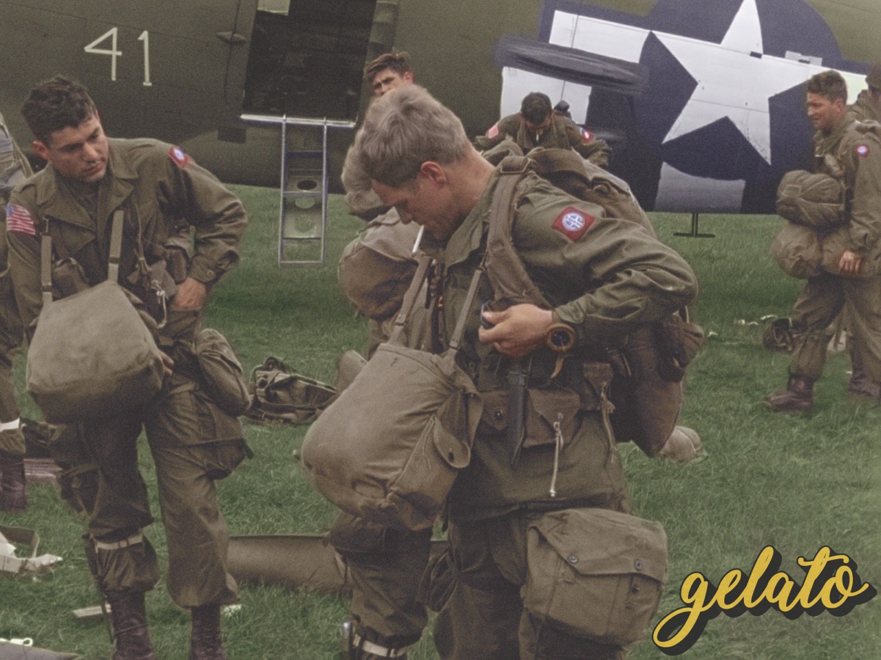 A vibrant colour of a solider with multiple bags around his next. He stands outside next to a plane