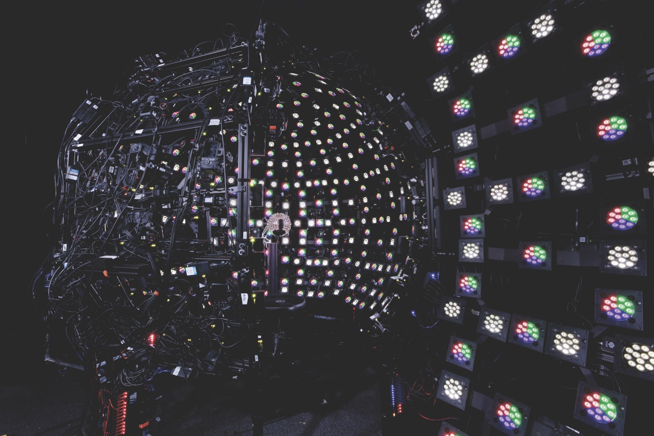 A globe made of lights with glowing lights to the right, against a black background