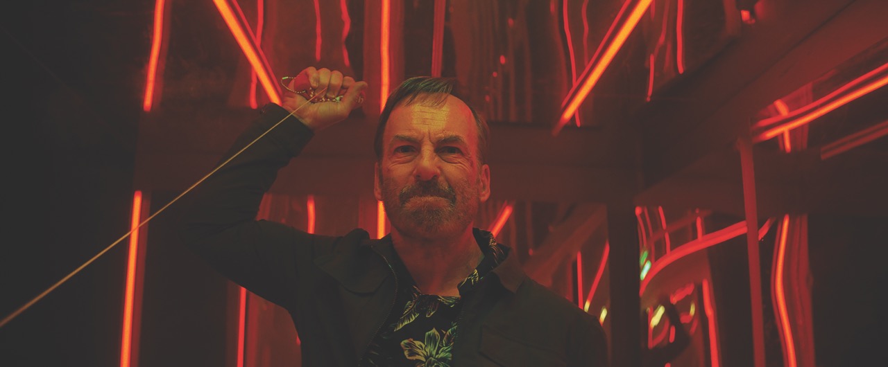 A man pulling a wire in a red room