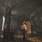 A still from Frankenstein showing a man looking up at a monster on a device