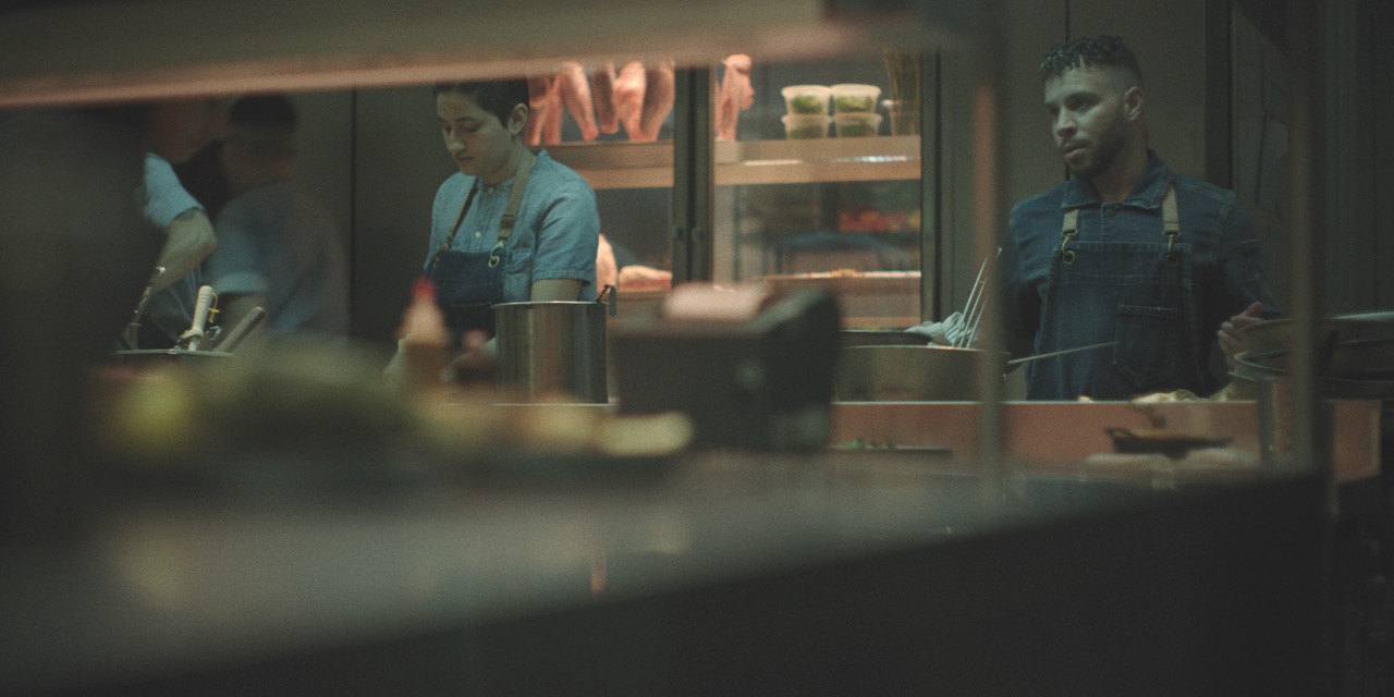 A still from Black Rabbit showing people working in a meat shop