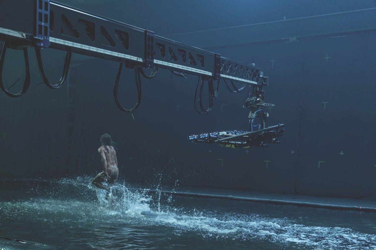 A photo from the set of 28 Years Later showing a camera on a rig filming a zombie skating across water