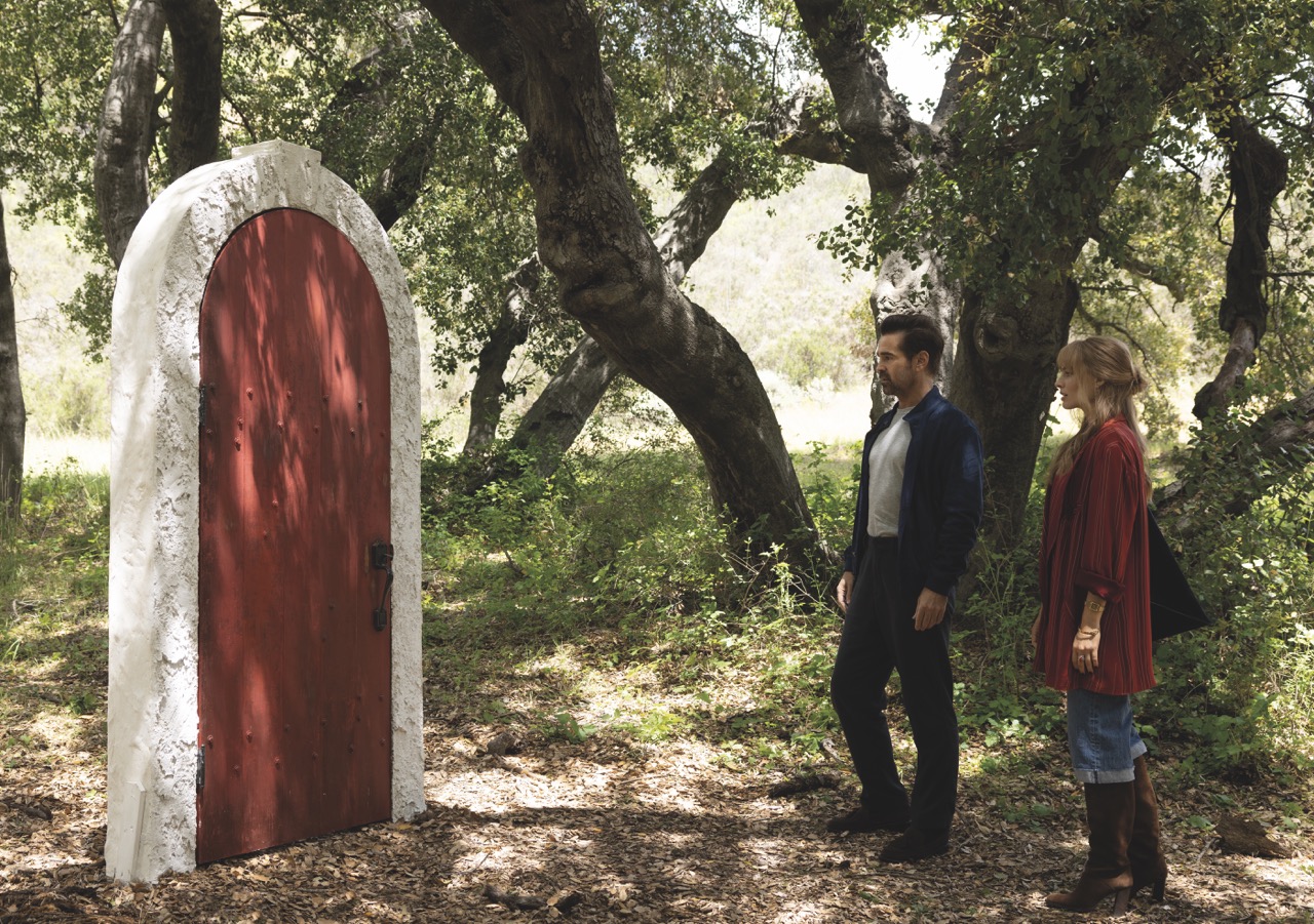 Kogonada and Farrell had previously worked together on After Yang A still from A Big Bold Beautiful Journey with a man and a woman standing in a forest and looking at a red door