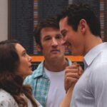 A still from Eternity showing a man holding a woman's hand to his heart, while another man stands between them