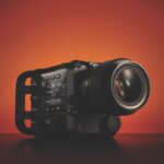 A Fujifilm camera, against a graduated red background