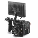 A professional camera by RED with a large monitor attached to the top, against a white background