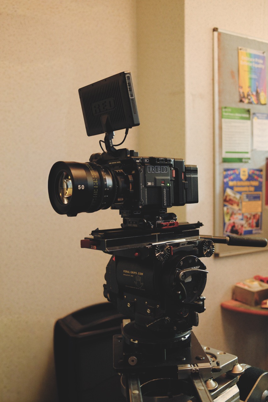 A large camera with a monitor attached, positioned in a classroom