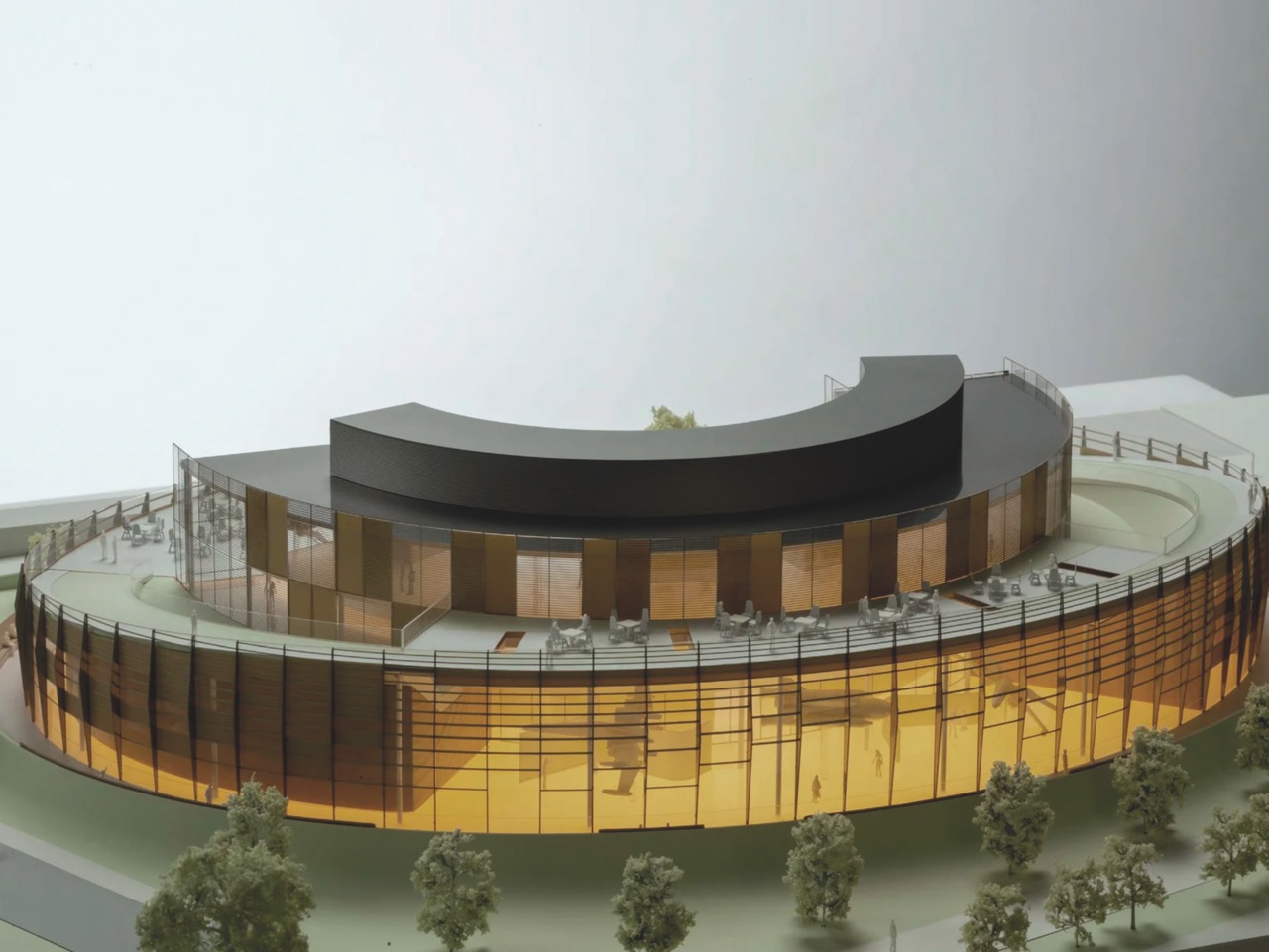 A mock-up of a curved building surrounded by trees