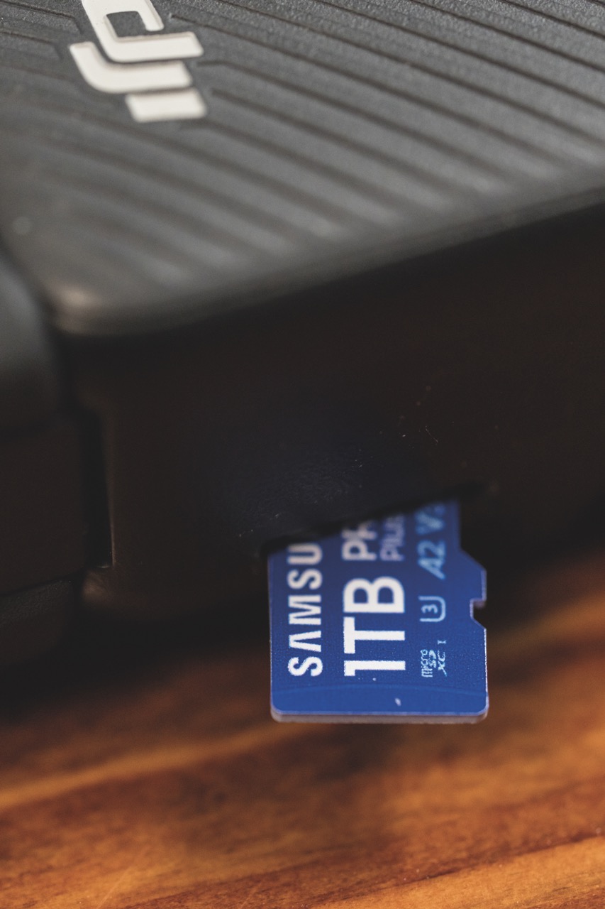 A small blue microSD card from Samsung, sticking out of a port