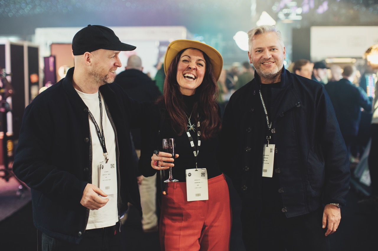 A group wearing ID badges while standing next to each other and smiling