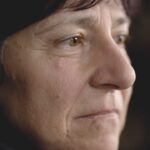 A close-up of a person's face, with a black background