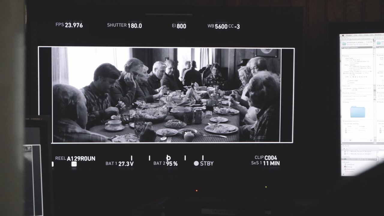 Passing (right) and Nebraska (this image) were originally shot in colour. Image Paramount A camera view showing a black and white image of actors around a large dinner table