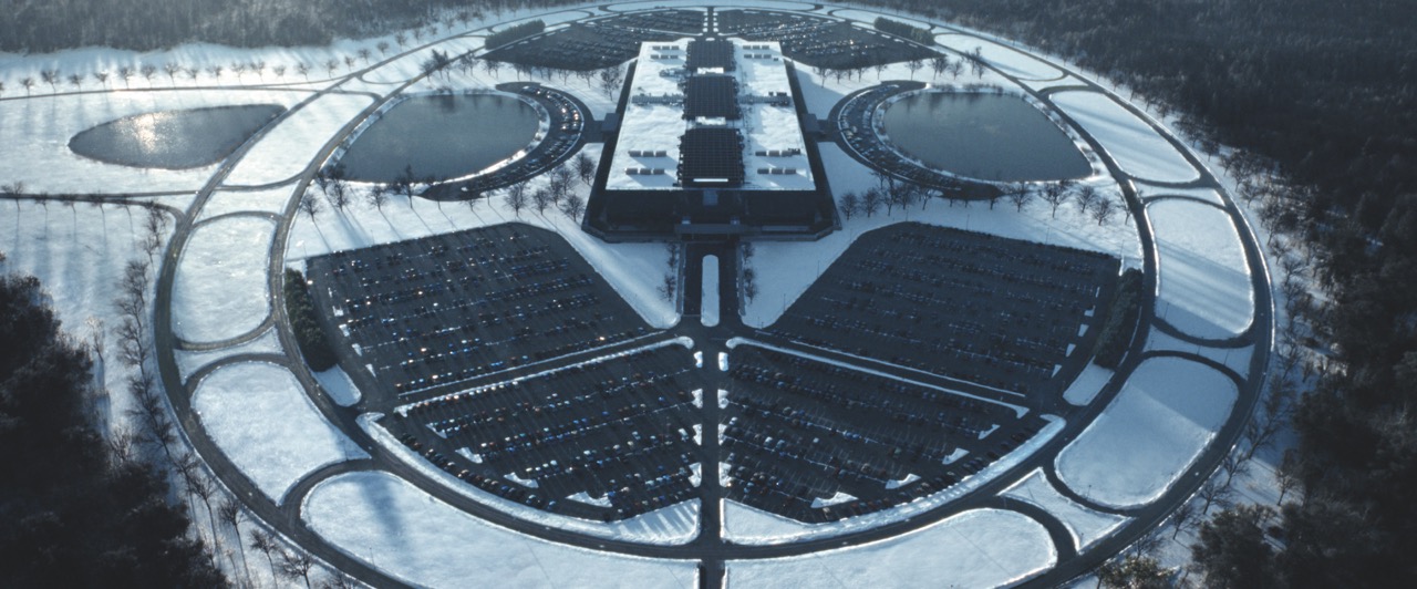 An aerial view of a circular complex covered in snow
