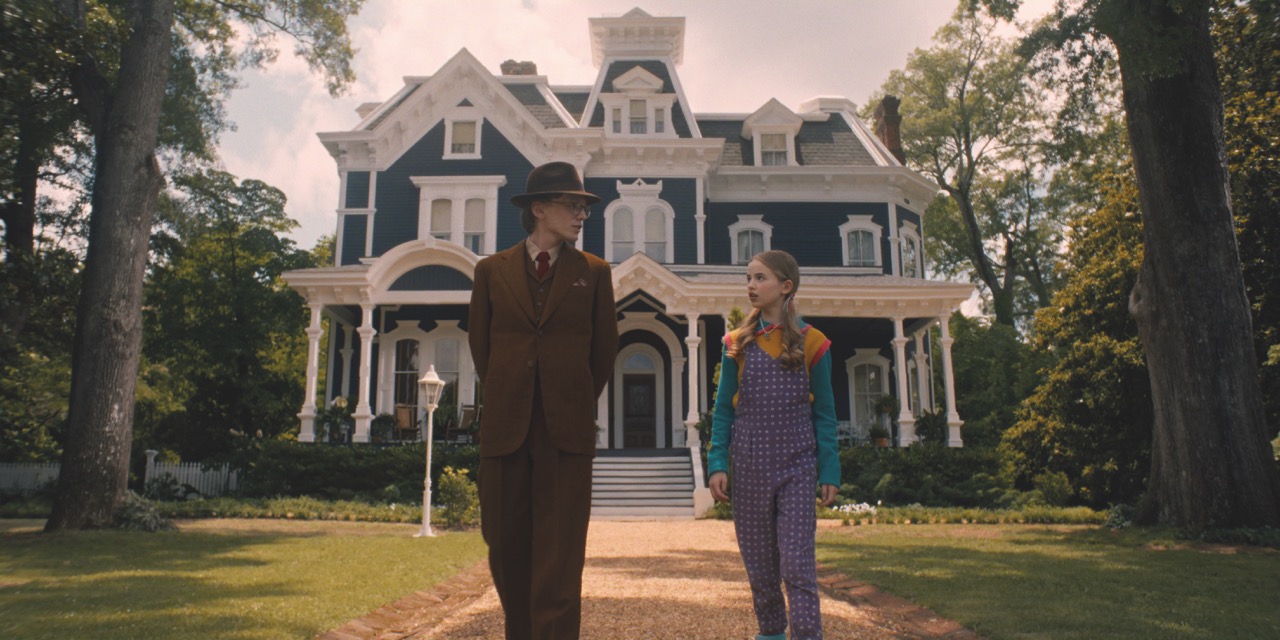 In Season 4, Henry Creel’s world has an almost Technicolor aesthetic Two people walking away from a grand house