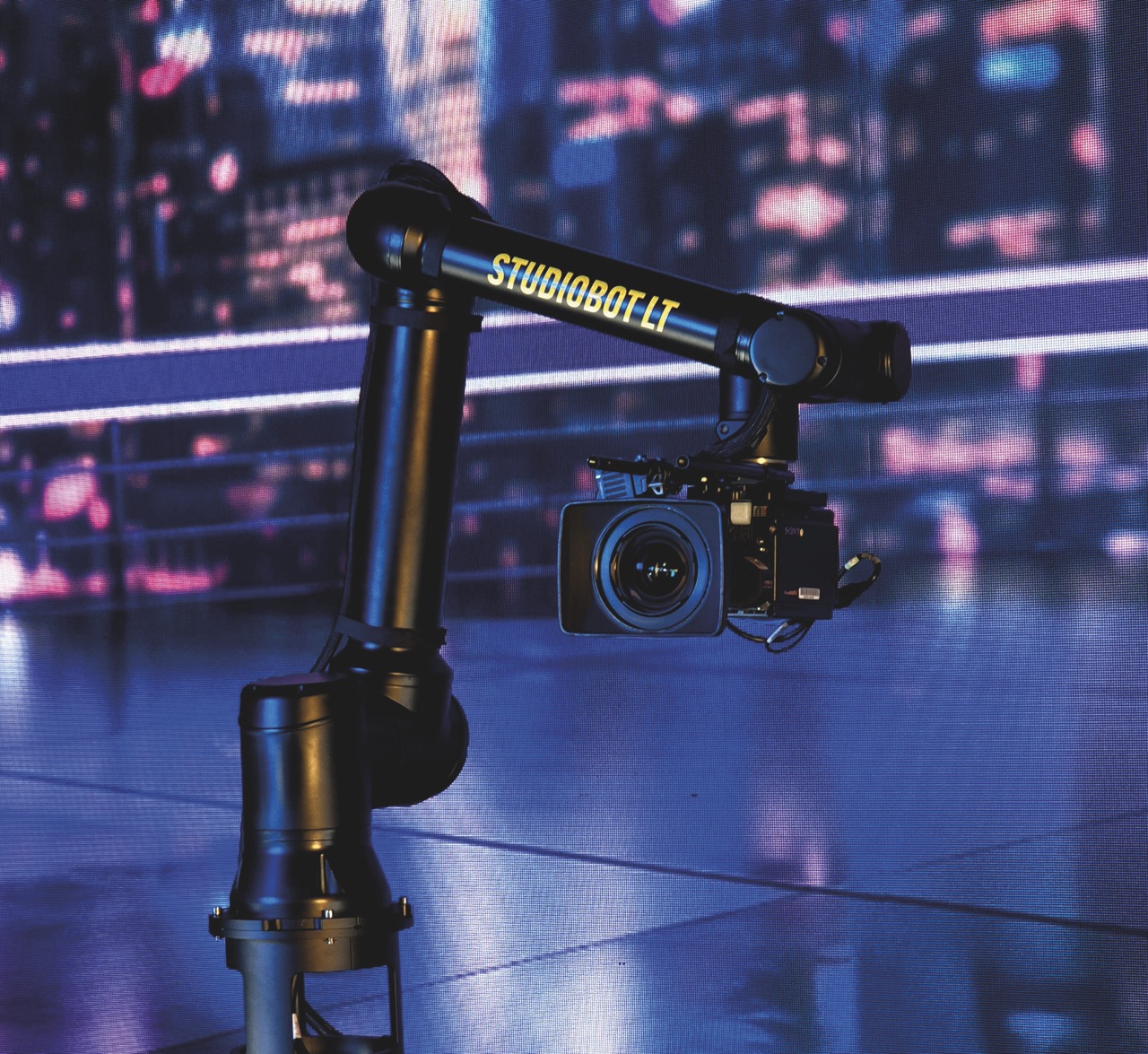 A camera attached to a robotic arm with blue lighting