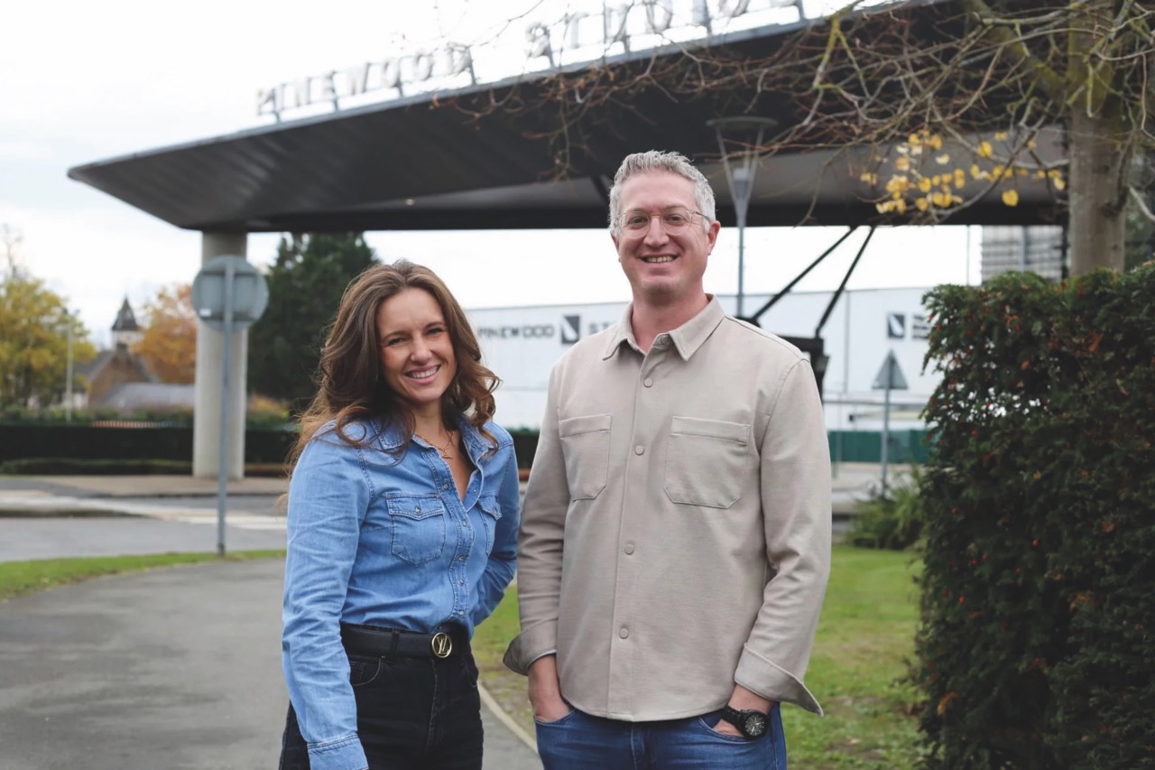 iMag opens new office at Pinewood Studios A man and woman standing outside in front of a concrete construction